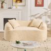 Beige curved two - person compress sofa. It has armrests on both sides, comes with two pillows, is suitable for small - sized apartments