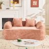 Pink curved two - person compress sofa. It has armrests on both sides, comes with two pillows, is suitable for small - sized apartments